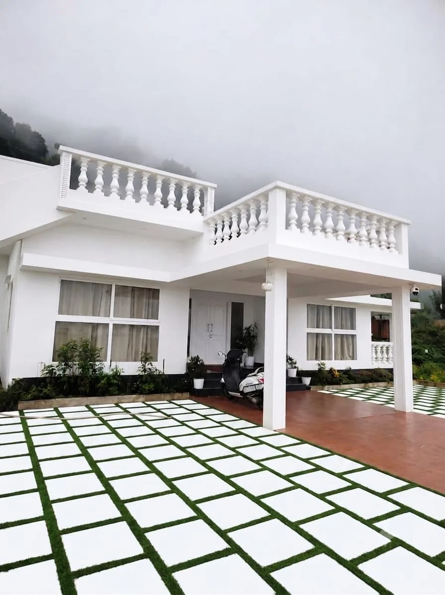 Front of the Adithya Resorts villa, Vagamon, with its paved courtyard
